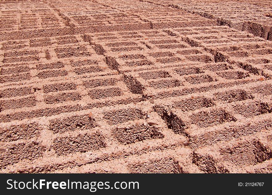 Concrete blocks used to build houses, buildings, office buildings and chimney. Orange red. Composition: cement, sand and lime. Perspective look. Factory of cement blocks. Concrete blocks used to build houses, buildings, office buildings and chimney. Orange red. Composition: cement, sand and lime. Perspective look. Factory of cement blocks