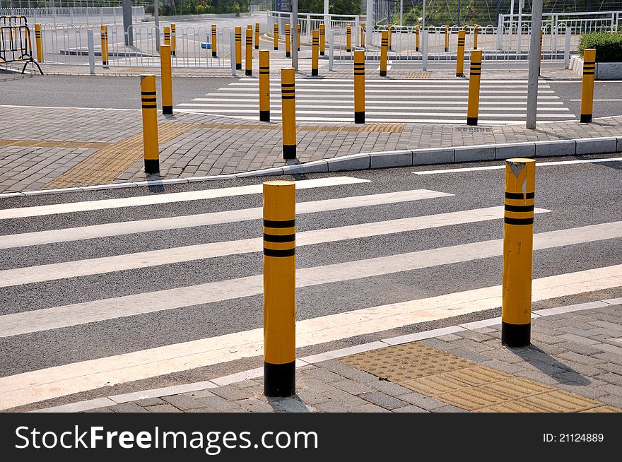 Traffic sign and facilities, such as zebra crossing and side of the road, at road corssing, shown as transportation or construction industrial concept, or way, reach, approach or complicated. Traffic sign and facilities, such as zebra crossing and side of the road, at road corssing, shown as transportation or construction industrial concept, or way, reach, approach or complicated.