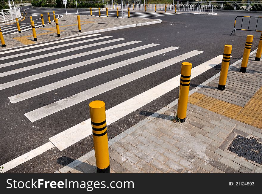 Traffic sign and facilities, such as zebra crossing and side of the road, at road corssing, shown as transportation or construction industrial concept, or way, reach, approach or complicated. Traffic sign and facilities, such as zebra crossing and side of the road, at road corssing, shown as transportation or construction industrial concept, or way, reach, approach or complicated.