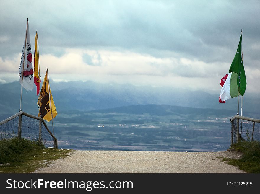 An old road from Switzerland to France with flags. An old road from Switzerland to France with flags