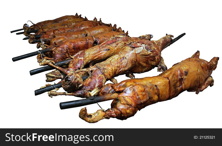 Whole Pig and Lamb Being Roasted - isolated on a white background.