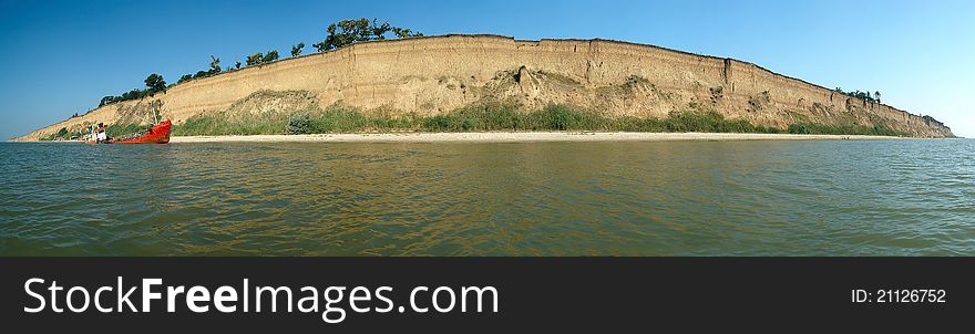 Panorama of a beach and the wrecked ship