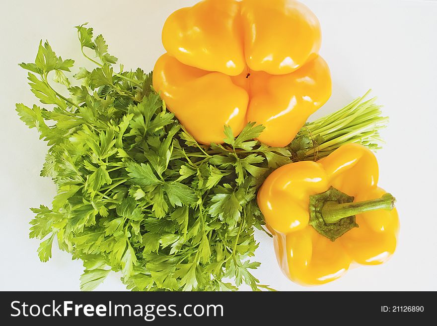 Yellow pepper and parsley on a white background