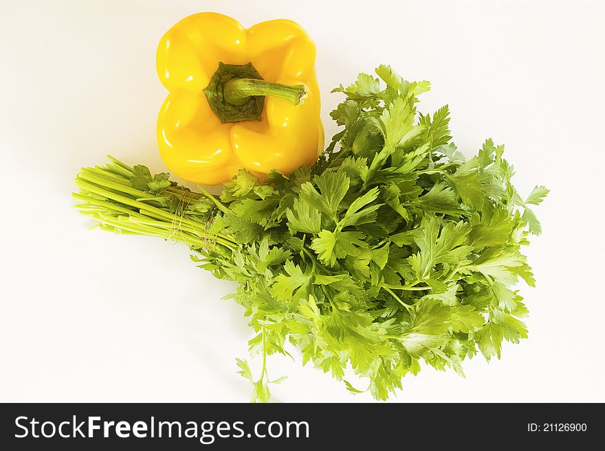 Yellow pepper and parsley on a white background