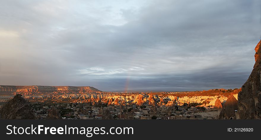 Panorama of Goreme valley early morning sun rays, heavy clouds rainbow, landscape, copy space and crop space. Panorama of Goreme valley early morning sun rays, heavy clouds rainbow, landscape, copy space and crop space