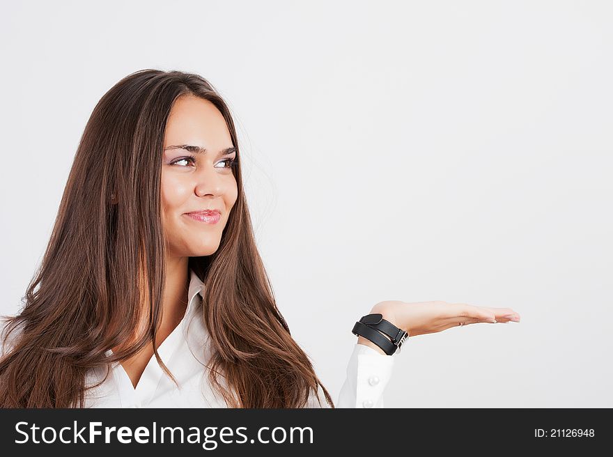 Beautiful woman showing something on the palm of her hand