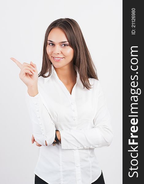 Happy smiling young business woman showing blank area for sign or copyspase, isolated on white background