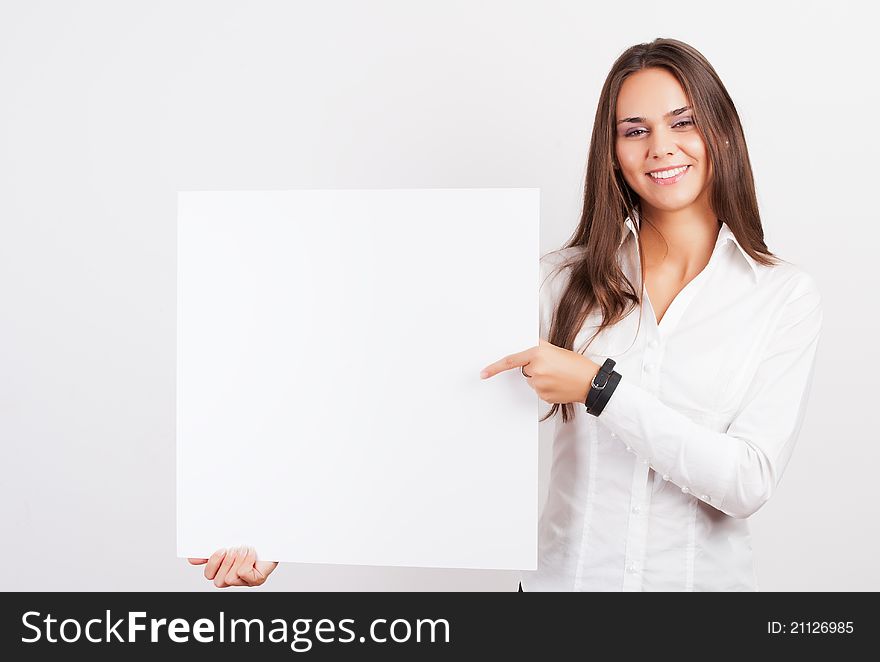 Happy smiling young business woman showing blank signboard, over white background
