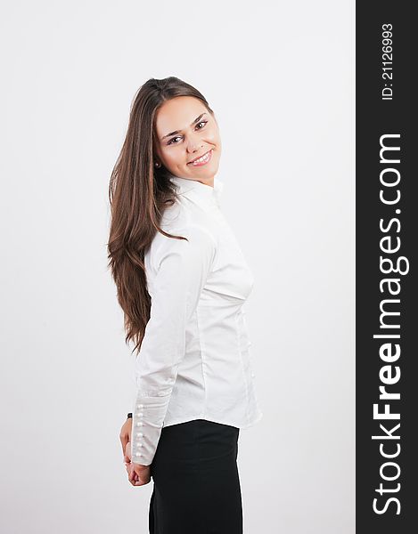 Portrait of a happy young woman smiling against white background