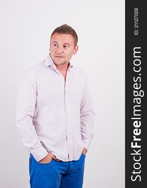 Portrait of the young happy smiling man on a white background