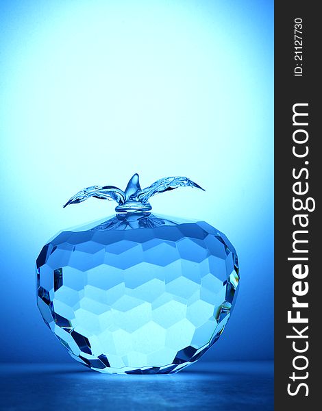 Crystal apple on blue background