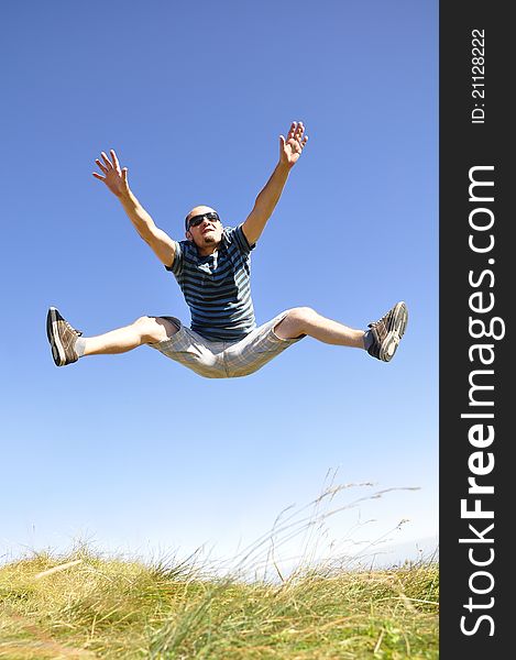 Happy young male jumping in the air