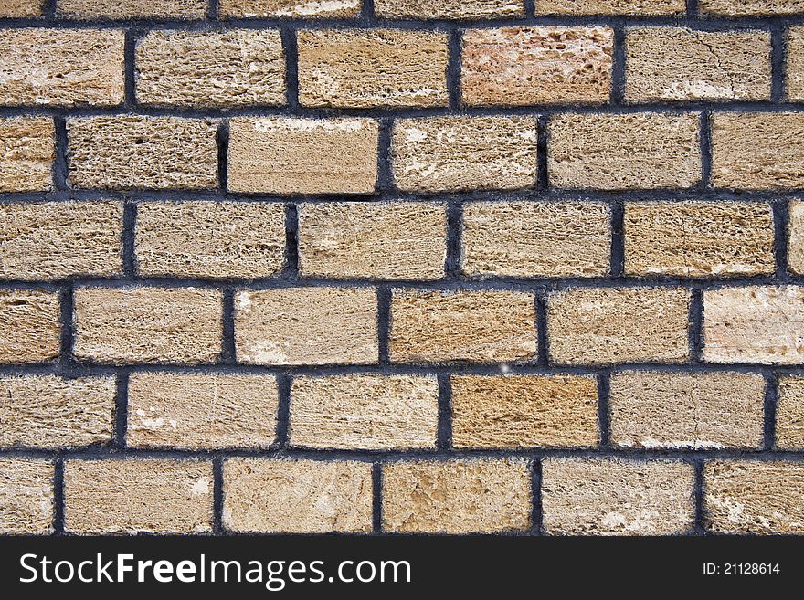 Brick wall made from yellow a shell rock. Brick wall made from yellow a shell rock