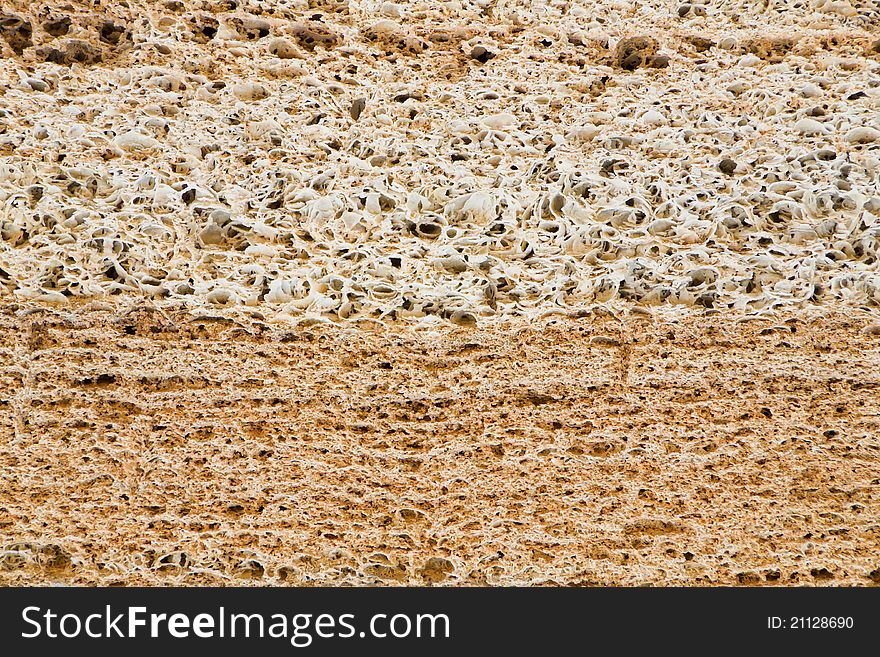 Layers of a natural building material of yellow and white colour. Layers of a natural building material of yellow and white colour