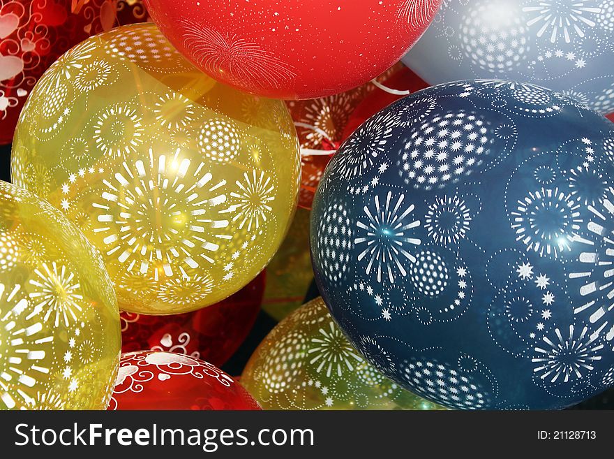 We see many colorful balloons with ornaments