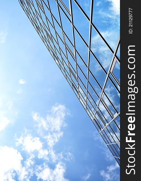High-rise glass building with sky and clouds reflection. High-rise glass building with sky and clouds reflection