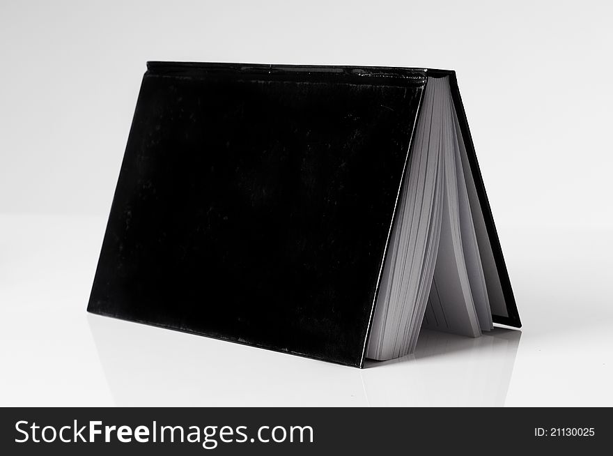 Black Book Open On A White Table