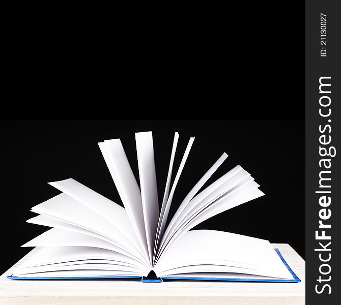 Open book on a black background for cutout