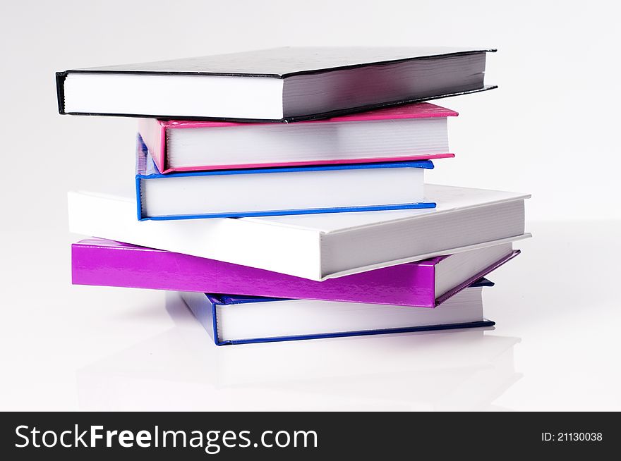 Six education school books on a white table