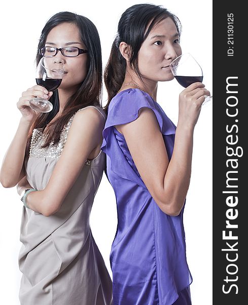 Two women next to each other in a bar having a drink. Two women next to each other in a bar having a drink