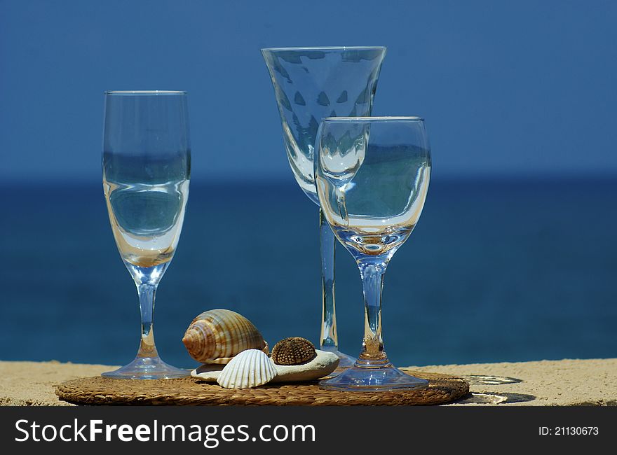 Three glasses of wine with a reflection of the sea and sky
