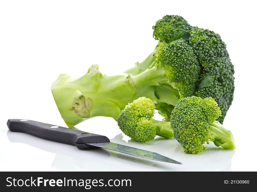 Broccoli and knife on white background