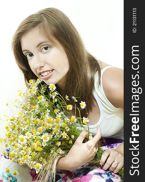 Young  smiling girl with bouquet of camomile against white background. Young  smiling girl with bouquet of camomile against white background