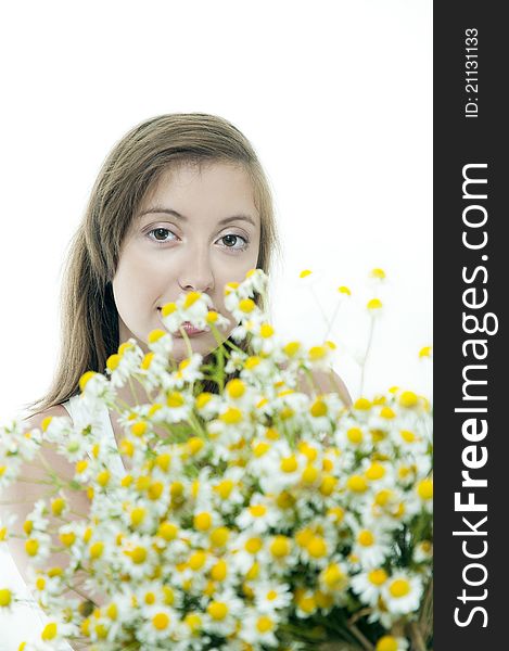 Young   brunette  with chamomile against white  background. Focus at the girl. Young   brunette  with chamomile against white  background. Focus at the girl