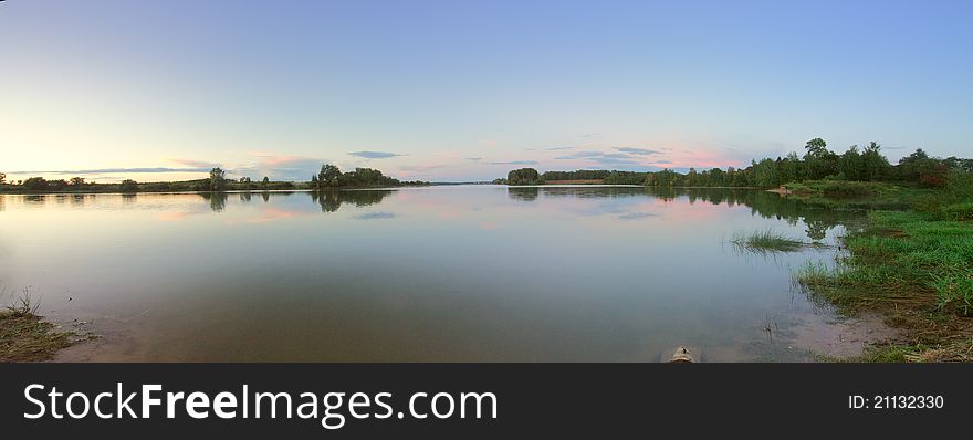 Summer panoramic landscape with beautiful lake at sunset. Ruzskoe lake in Russia. Summer panoramic landscape with beautiful lake at sunset. Ruzskoe lake in Russia