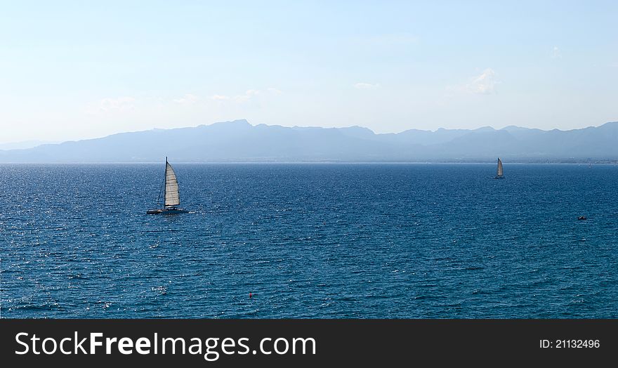 Sailboat in regatta on blue sea. Panorama