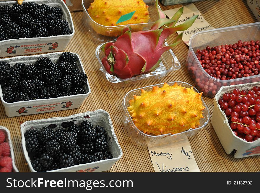 Blackberries cranberries rdberries and various tropical fruits in boxes for sale. Blackberries cranberries rdberries and various tropical fruits in boxes for sale