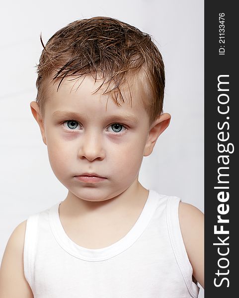 The pensive caucasian boy with wet hair