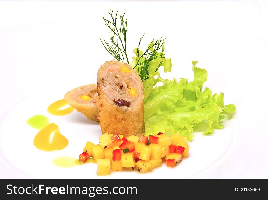 Fried spring rolls cut in half garnish with salad leaves and dill