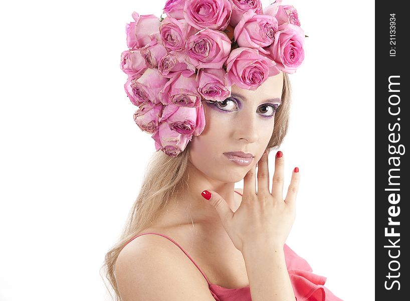 Young beautiful woman with pink flowers on her head over white