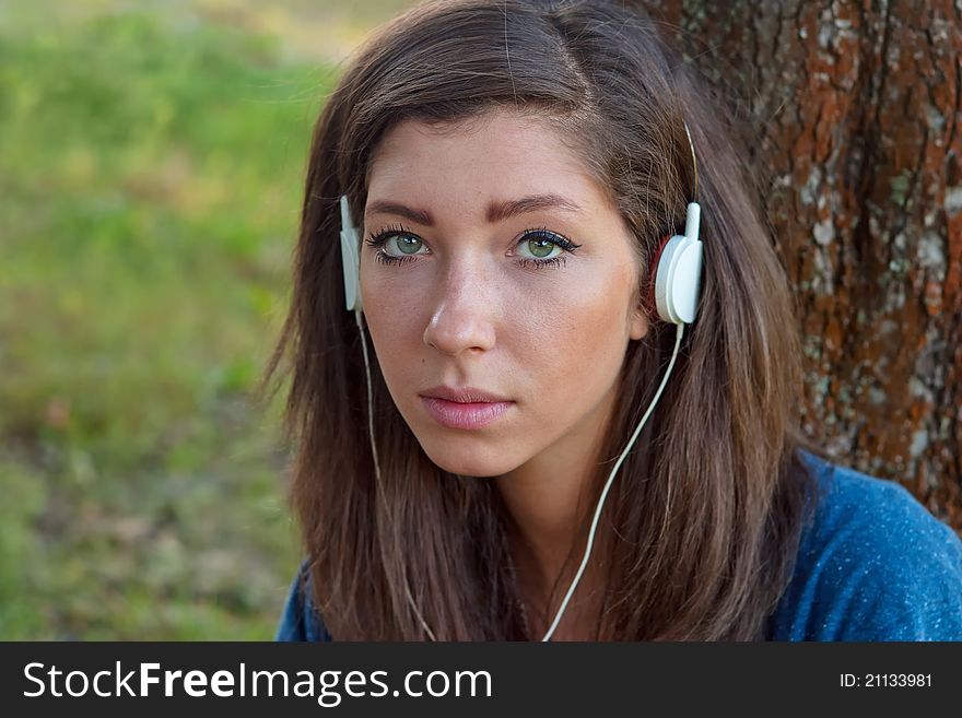 Young woman listening to music on headphones. Young woman listening to music on headphones