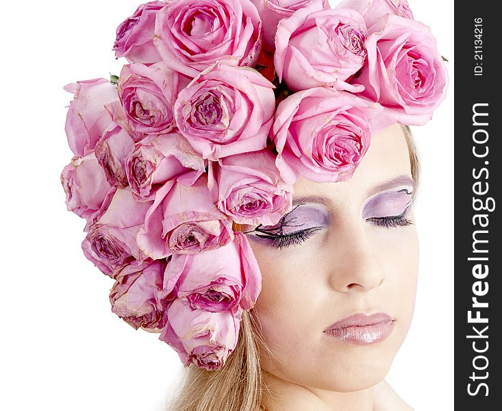 Young beautiful woman with pink flowers on her head over white