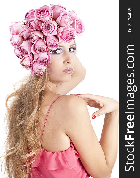 Young beautiful woman with pink flowers on her head over white