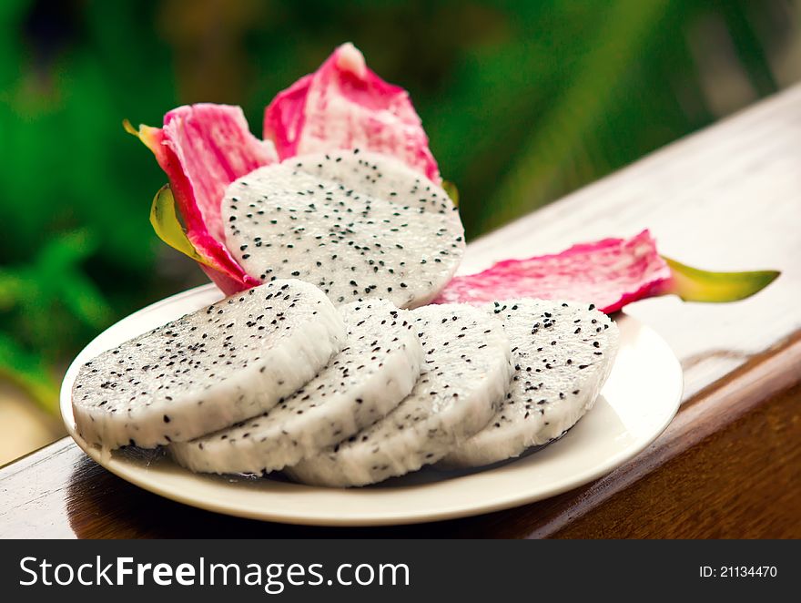Bright, Vivid and tasty fruit Dragon sliced on a plate. Bright, Vivid and tasty fruit Dragon sliced on a plate