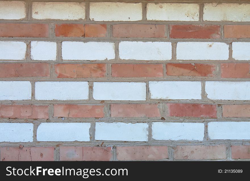 Old red and white striped brick wall, texture. Old red and white striped brick wall, texture
