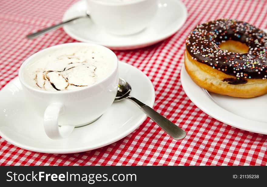 Donuts with coffee on table.