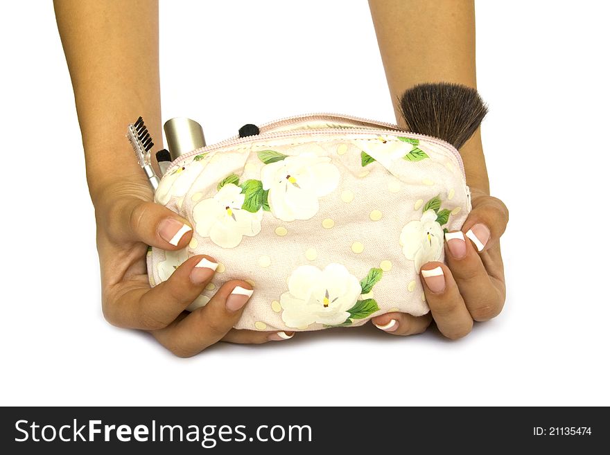 Bag of cosmetics in female hands on a white background. Bag of cosmetics in female hands on a white background