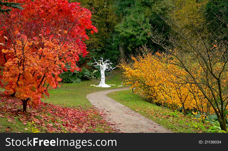 The white tree sculpture in the autumn backdrop