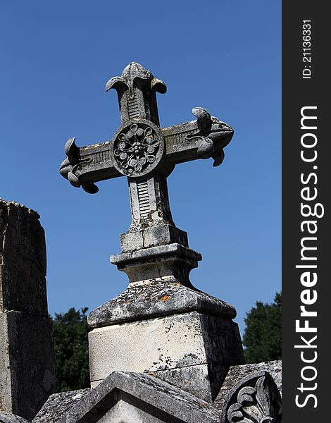 Old massive cross of a tombstone on a graveyard. Old massive cross of a tombstone on a graveyard