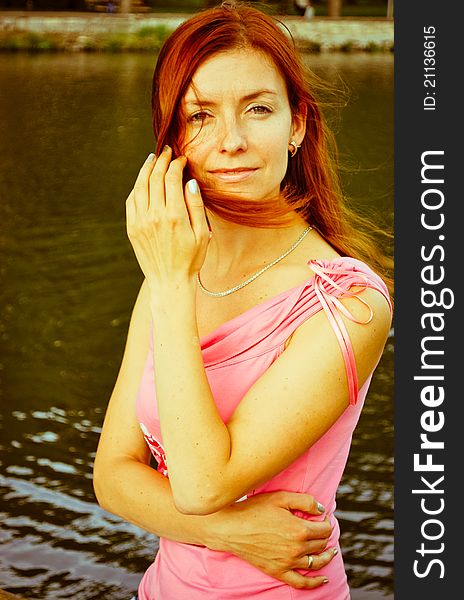 Beautiful woman standing near lake. Beautiful woman standing near lake