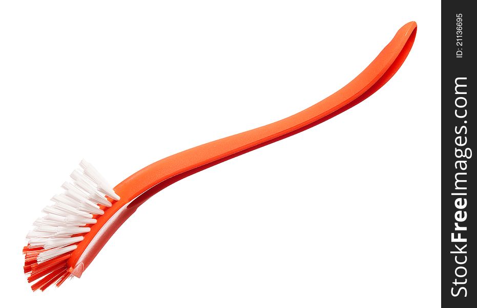 Plastic orange brush for washing dishes on a white background