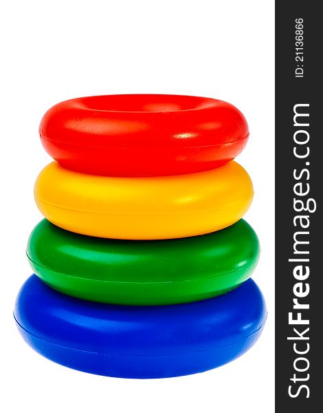 Colorful round plastic toys stacked over white background. Colorful round plastic toys stacked over white background.