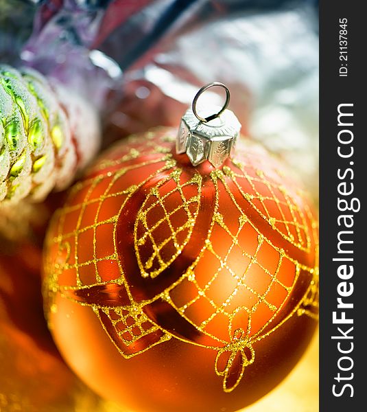 Christmas-tree decorations. One red ball is in focus.