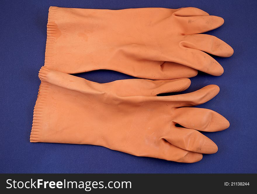 Orange rubber gloves in studio photography
