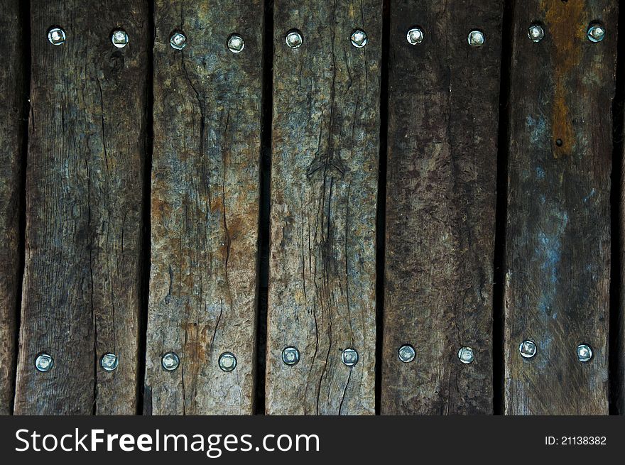 Old wooden boards with stainless steel bolts in