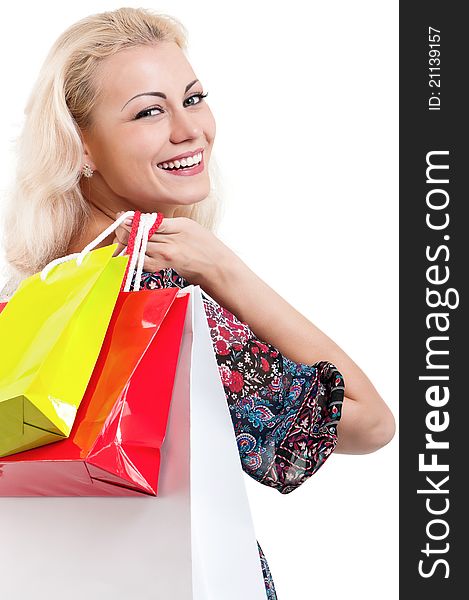 Portrait of a young woman holding a shopping bags over white background. Portrait of a young woman holding a shopping bags over white background